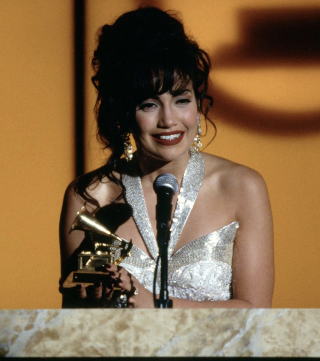 Jennifer Lopez as Selena, accepting a Grammy award