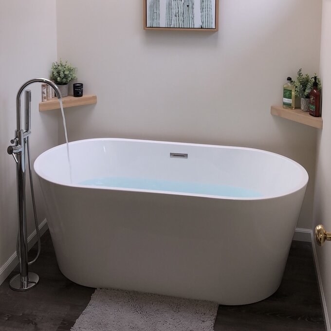 The soaking tub styled in a bathroom