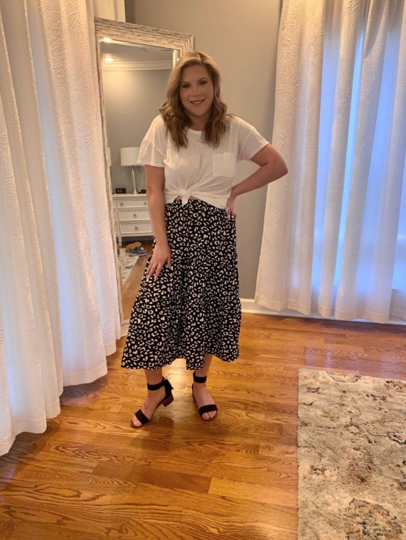 Reviewer wearing black and white leopard print midi skirt with white top
