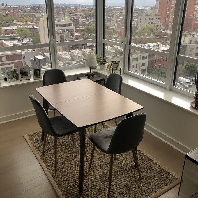 a reviewer photo of the table with chairs in front of windows