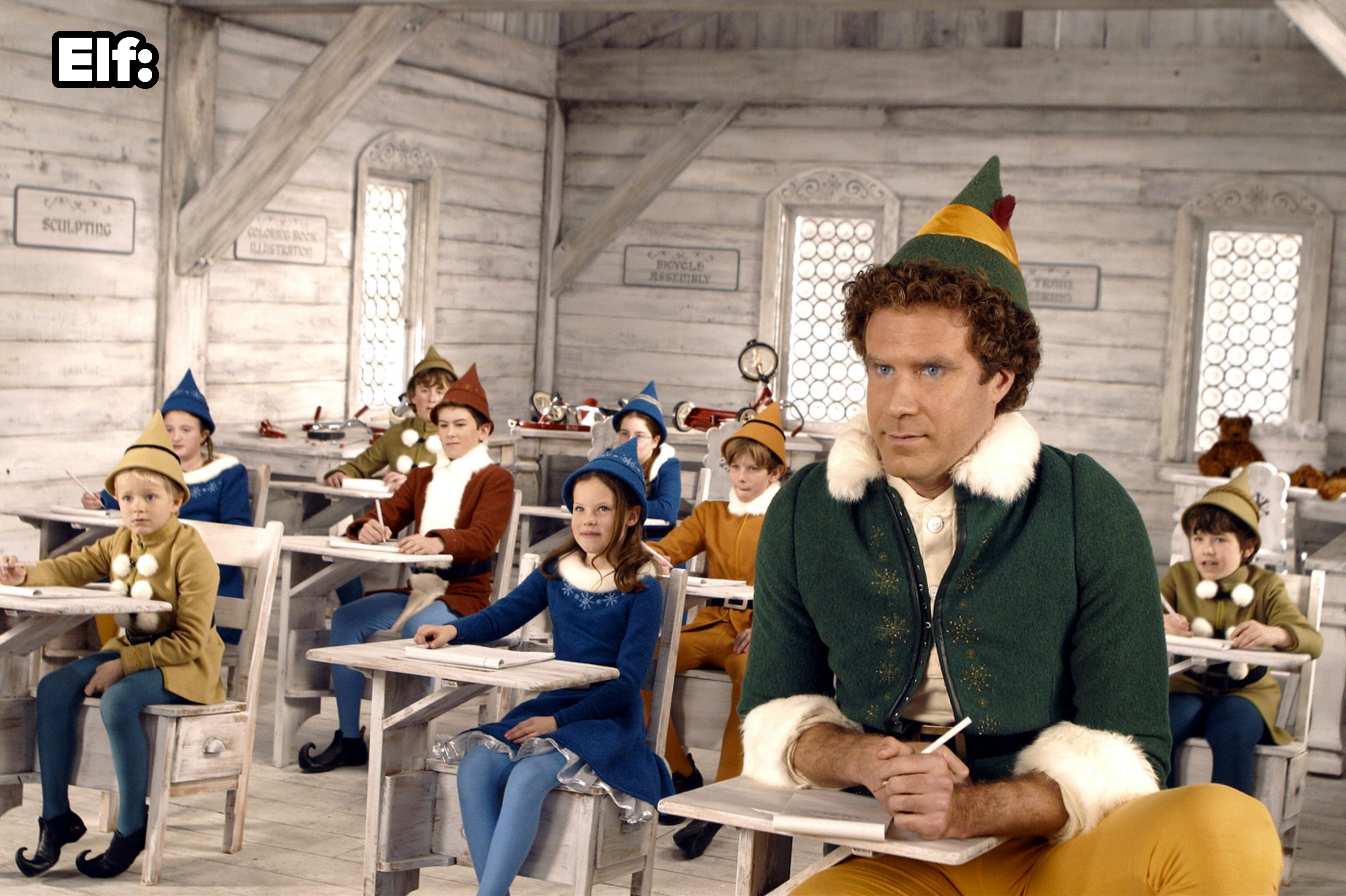 Will Ferrell looking like a giant sitting in a small desk in Elf