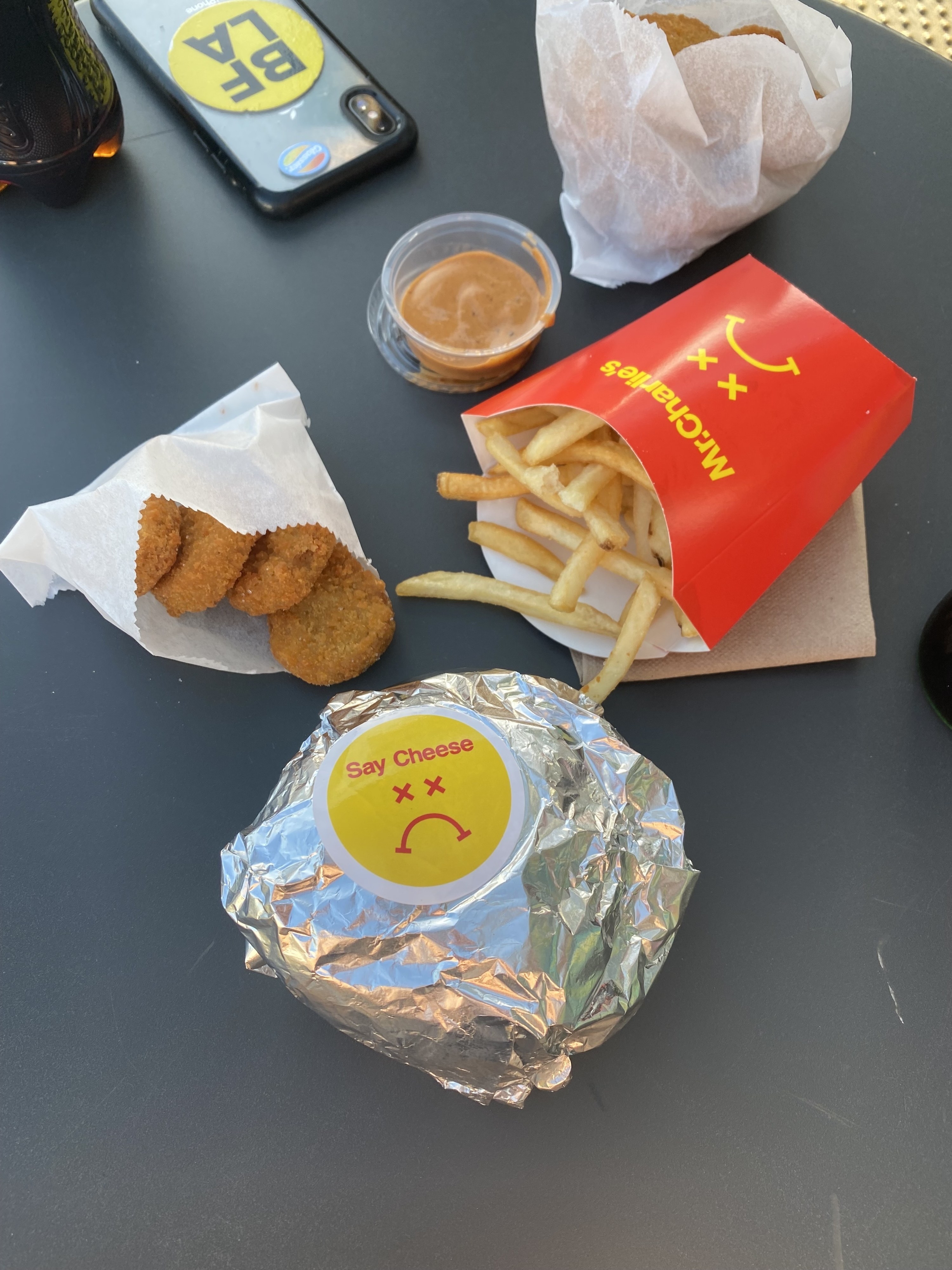 wrapped not a burger, fries, nuggets, and sauces on a table