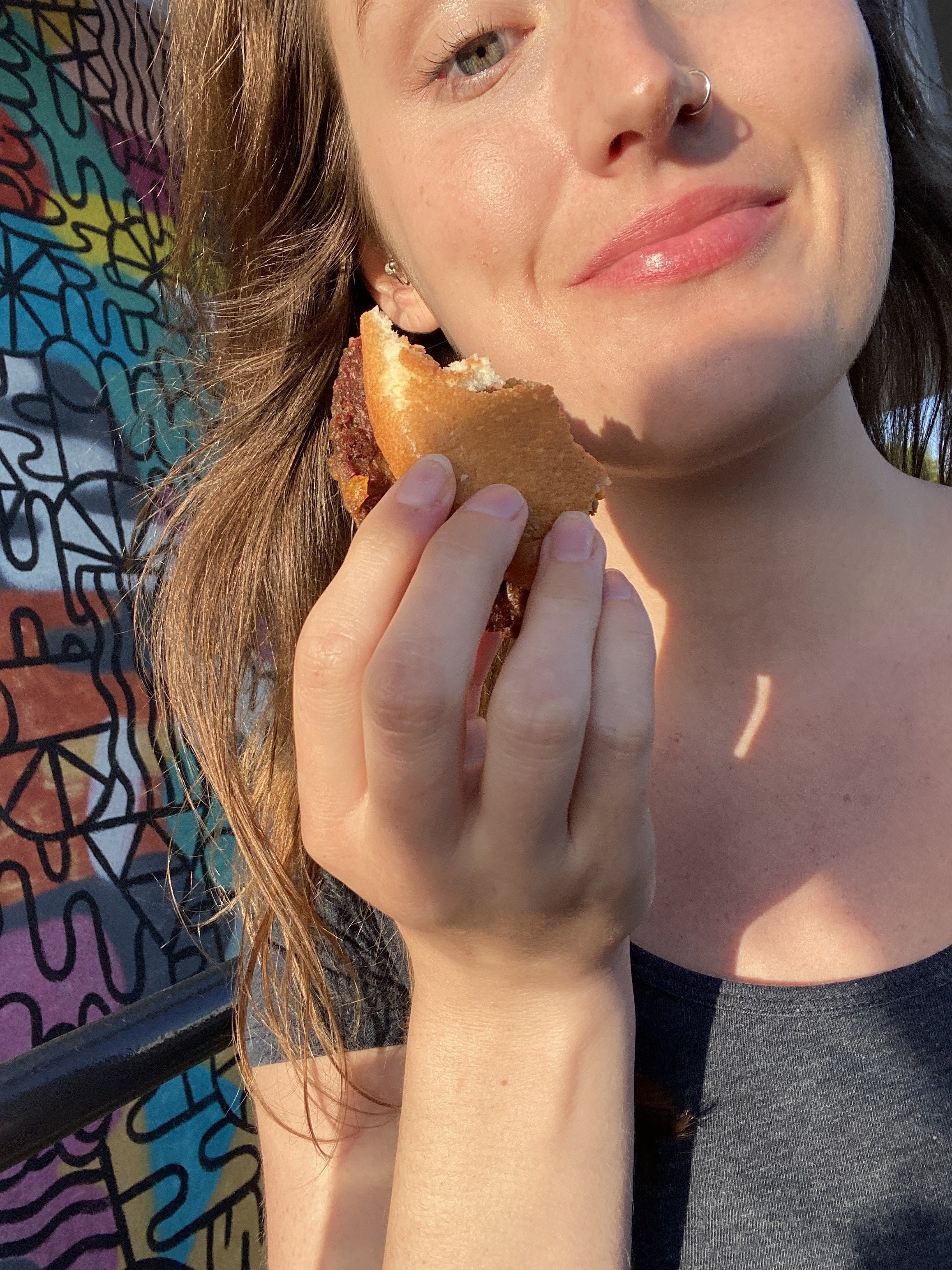 the author holding the final bite in front of her face