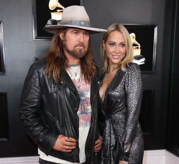 Billy Ray and Tish Cyrus posing for a photo together at the Grammys