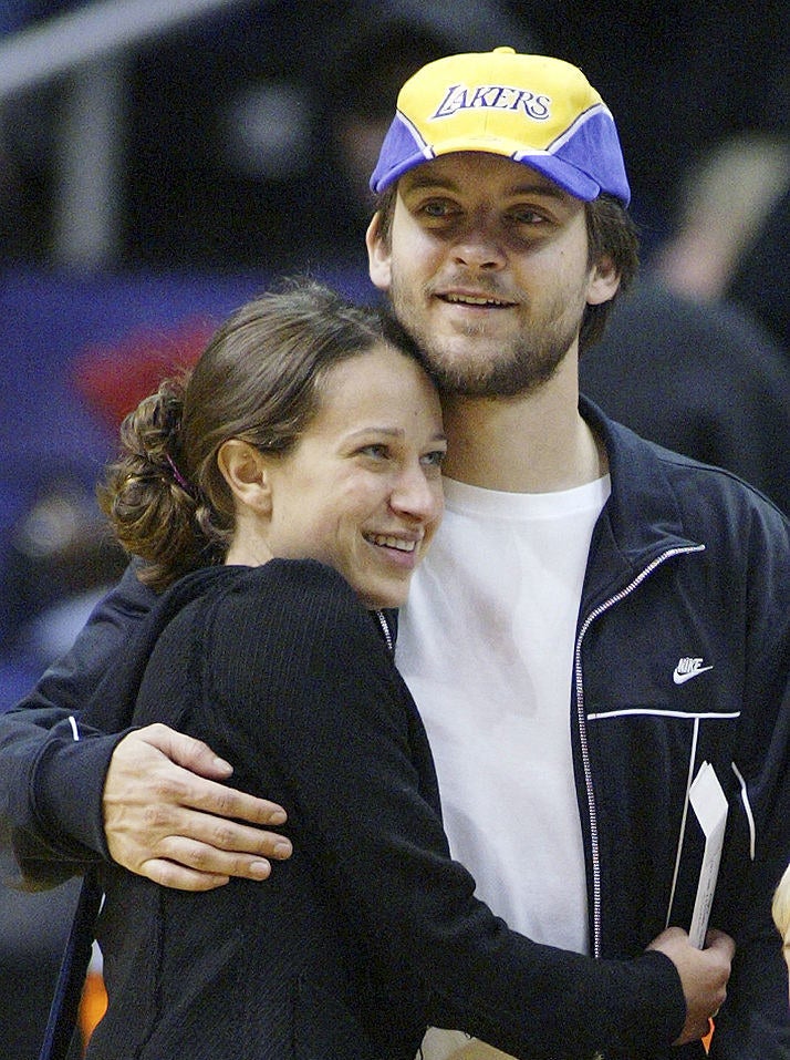 Tobey Maguire and Jennifer Meyer holding each other and smiling