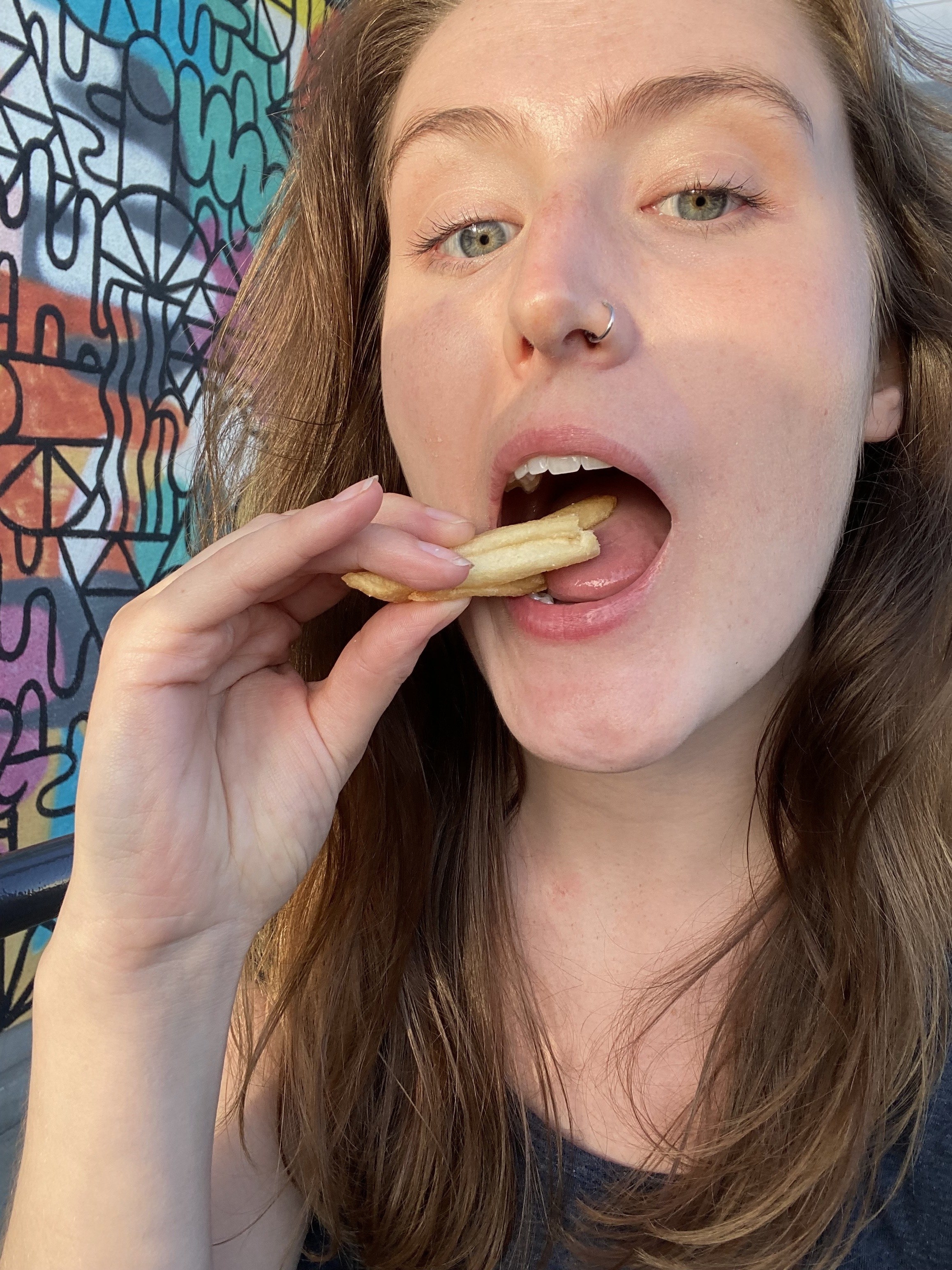 the author putting the fries in her mouth