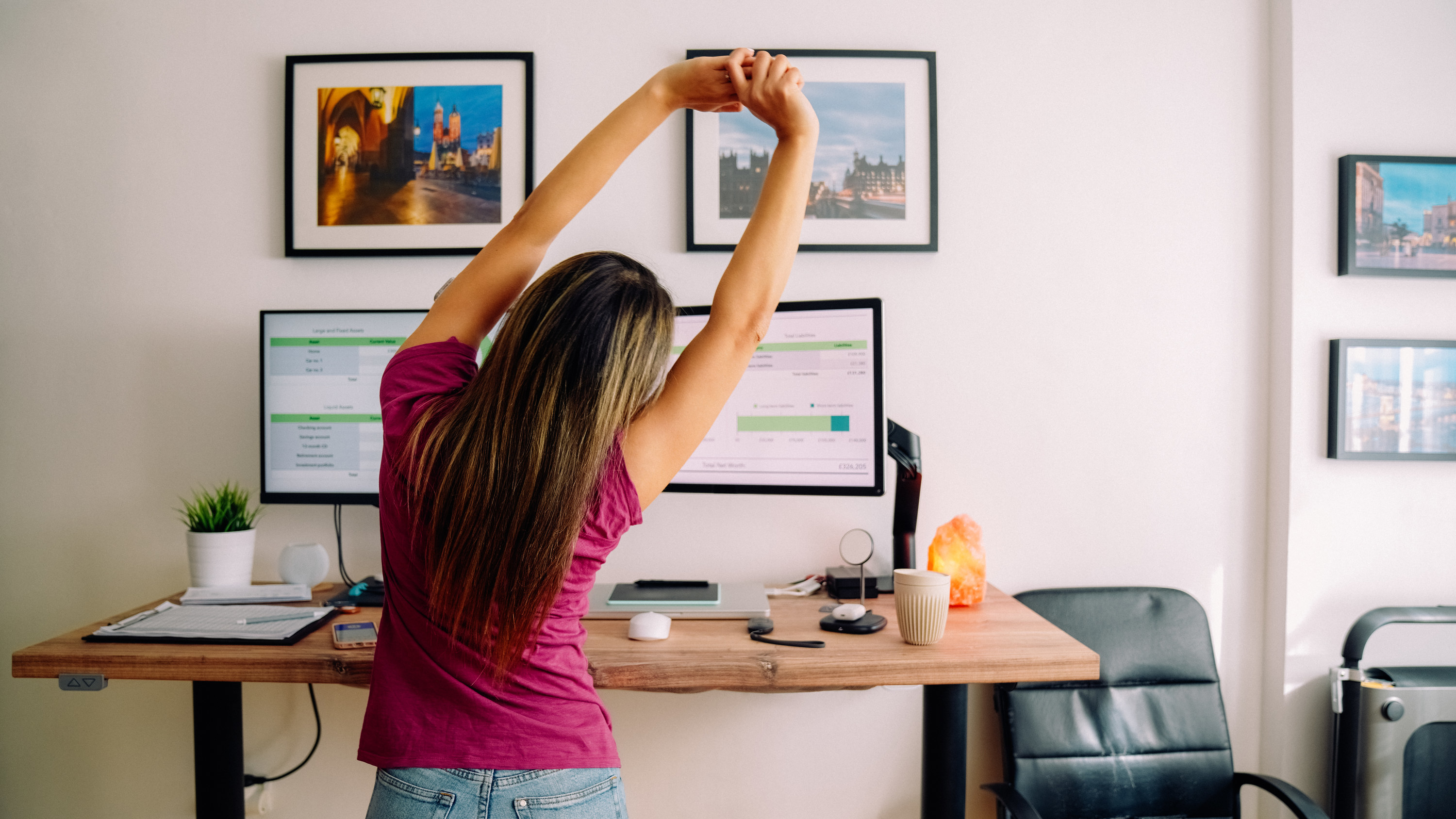 Woman stretching in front of her standing desk