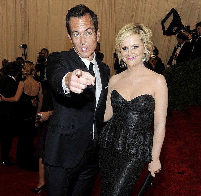 Will Arnett pointing and Amy Poehler smiling at a fancy event