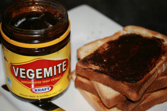 A jar of Vegemite next to a stack of Vegemite toast