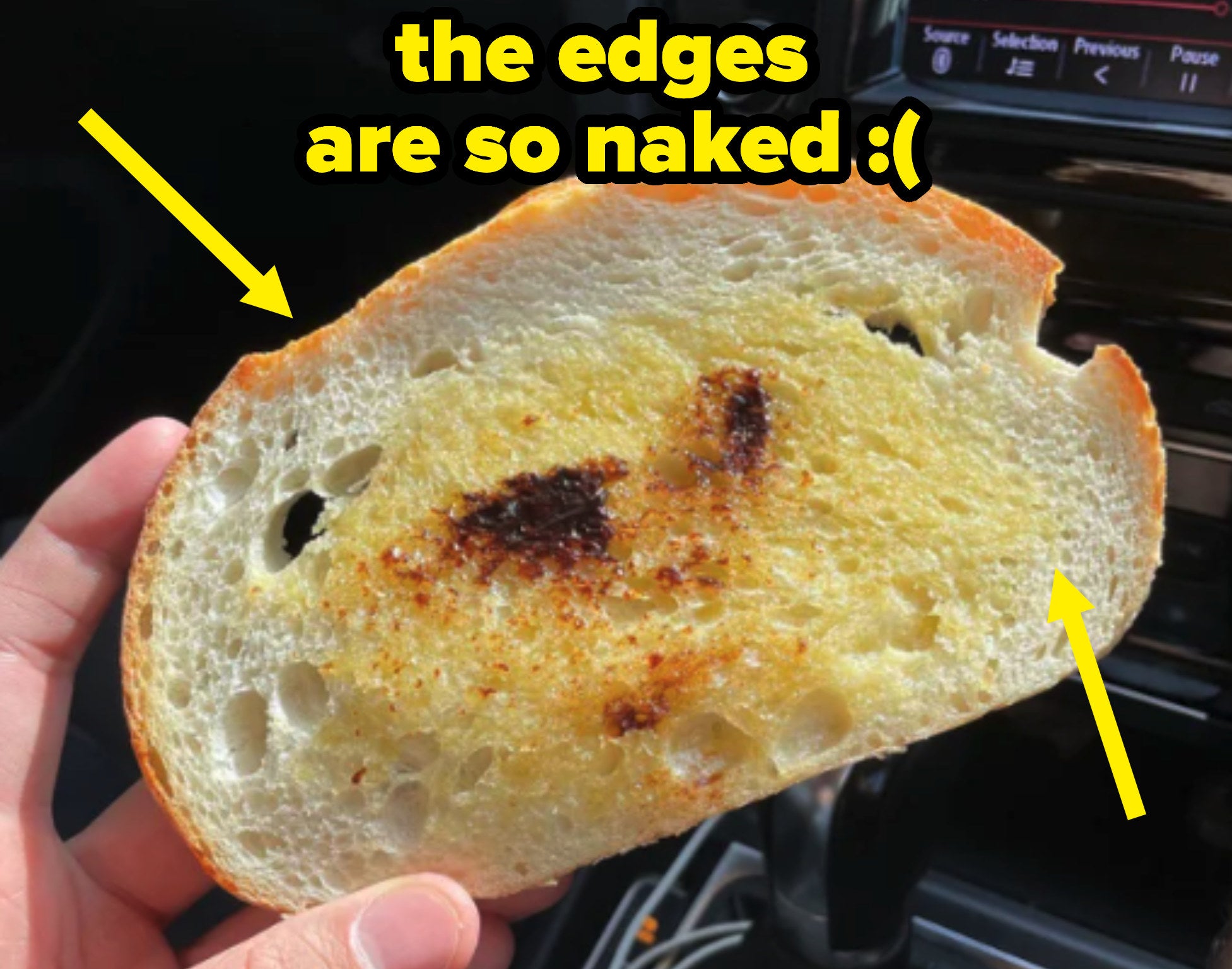 A close up of the Vegemite toast; there are arrows highlighting how the butter and Vegemite has not been spread to the edges