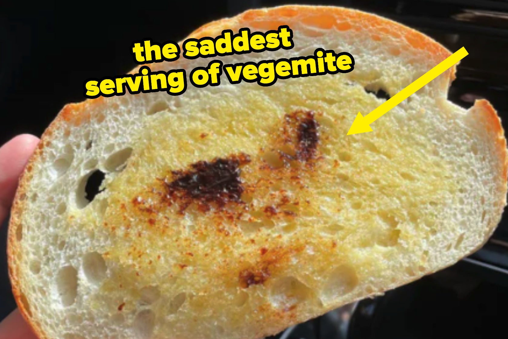 A close up of the Vegemite toast; there is an arrow highlighting the stingy application of Vegemite on the piece of toast