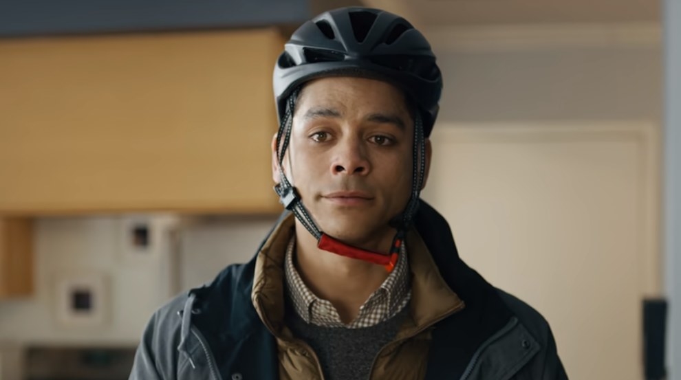 Alan wears a bicycle helmet as he talks to Nadia