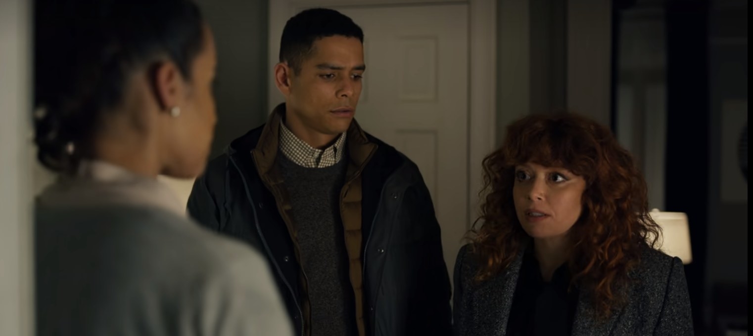 Nadia, Alan, and Beatrice stand in Beatrice&#x27;s apartment talking