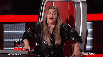 Kelly Clarkson gesturing on The Voice