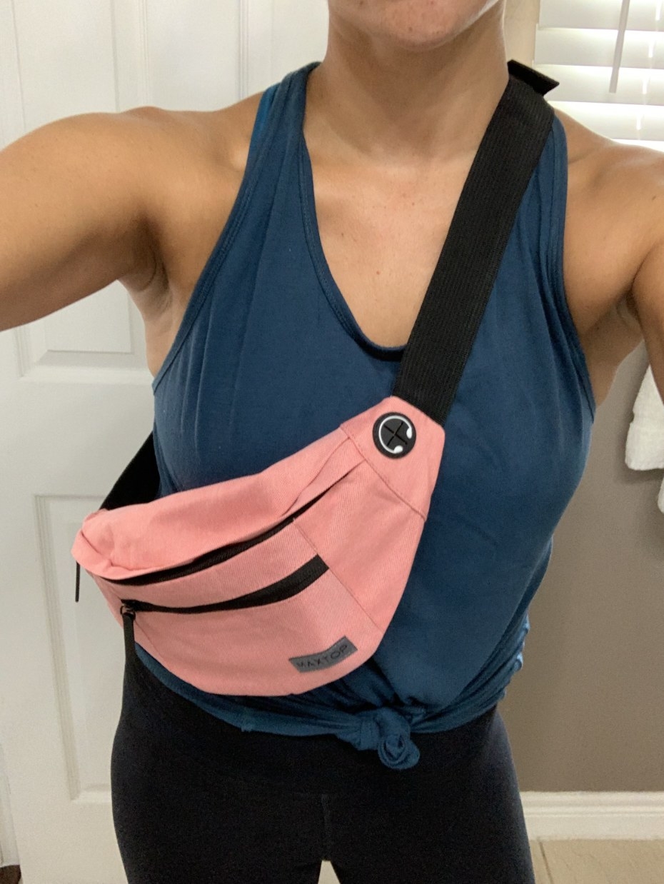 reviewer selfie while wearing the fanny pack in pink
