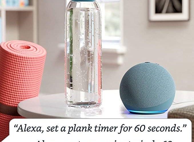 the smart speaker on a counter beside a bottle of water and a yoga mat