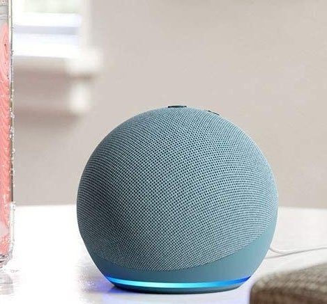 a round echo dot speaker on a white table