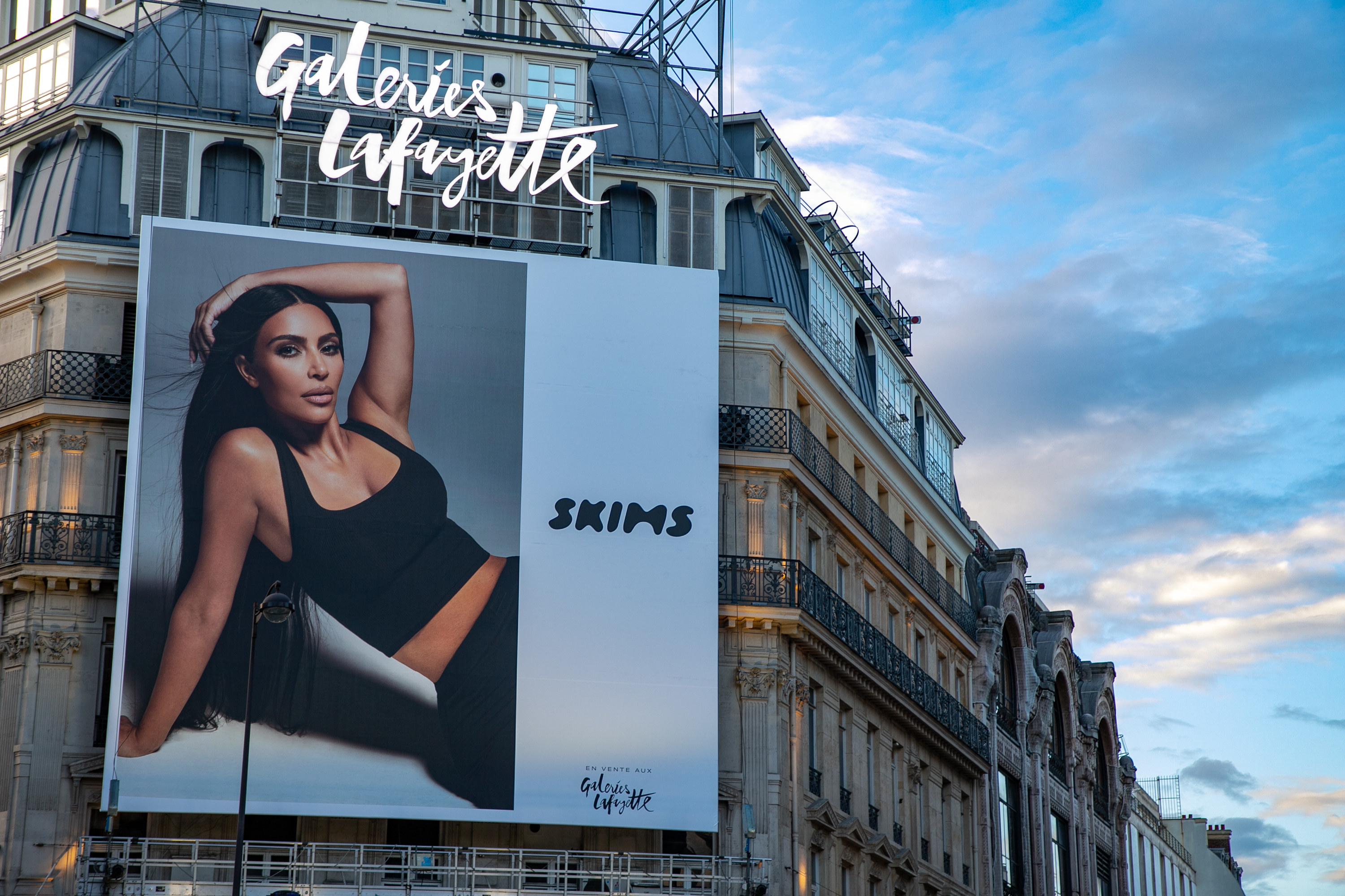 A billboard for Skims with a picture of Kardashian on a Paris building