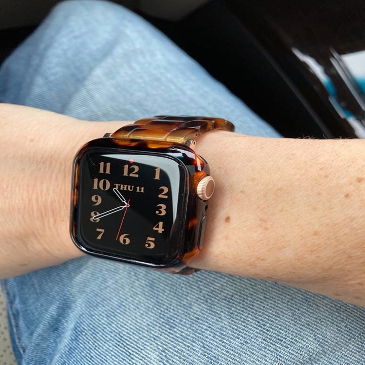 Reviewer wearing watch with tortoise shell band