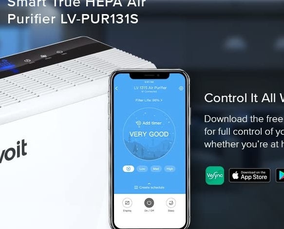 an air purifier next to a phone open to the app that controls it