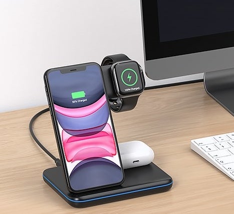 a charging station holding a phone, watch and earbuds case