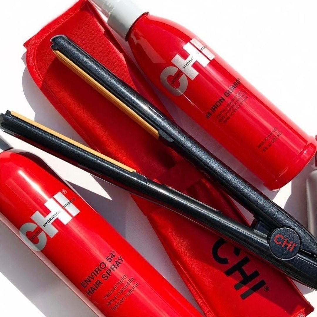 the flat iron on top of a bunch of hair products