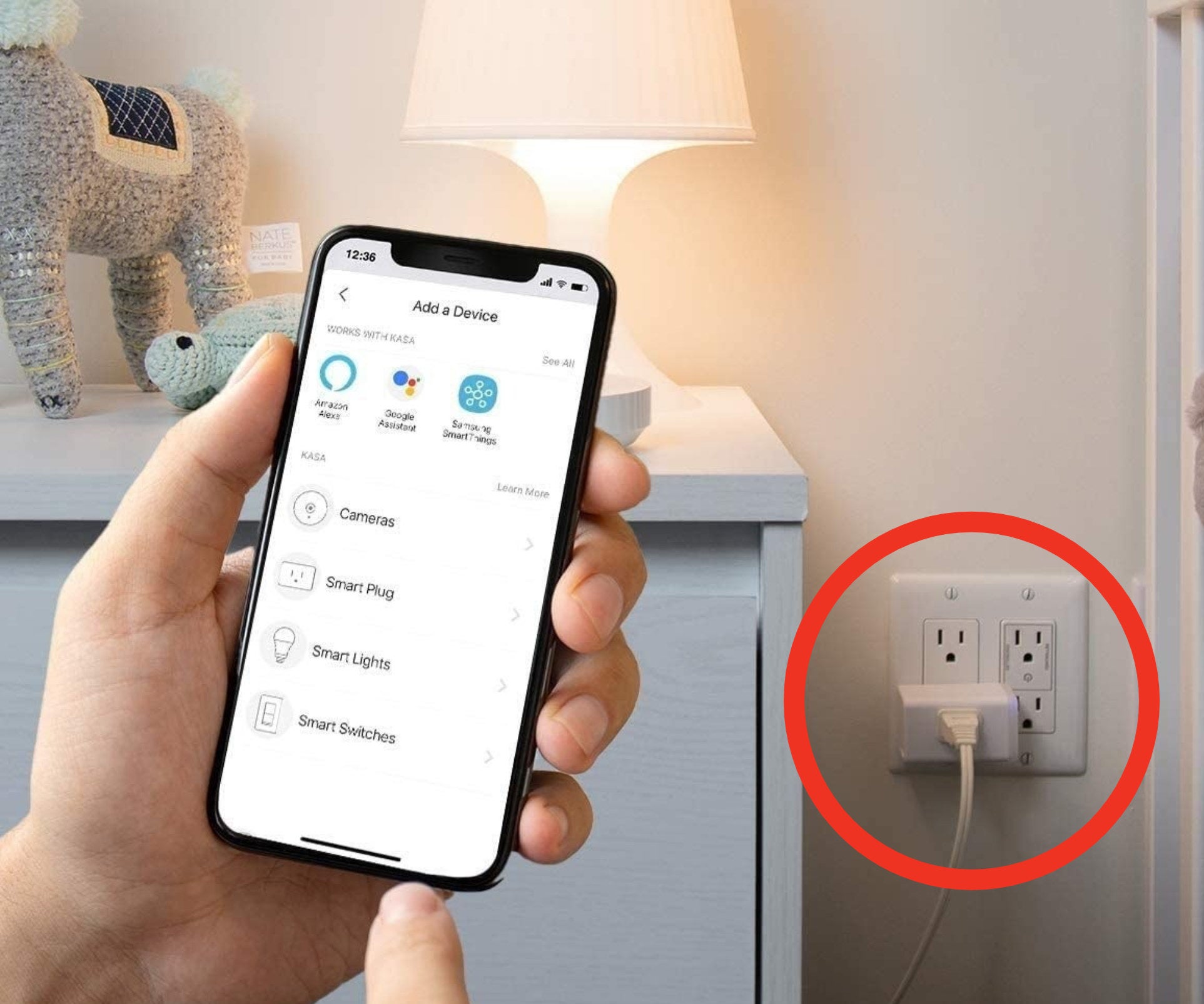 a person holding a phone, controlling the smart plug plugged into the wall outlet