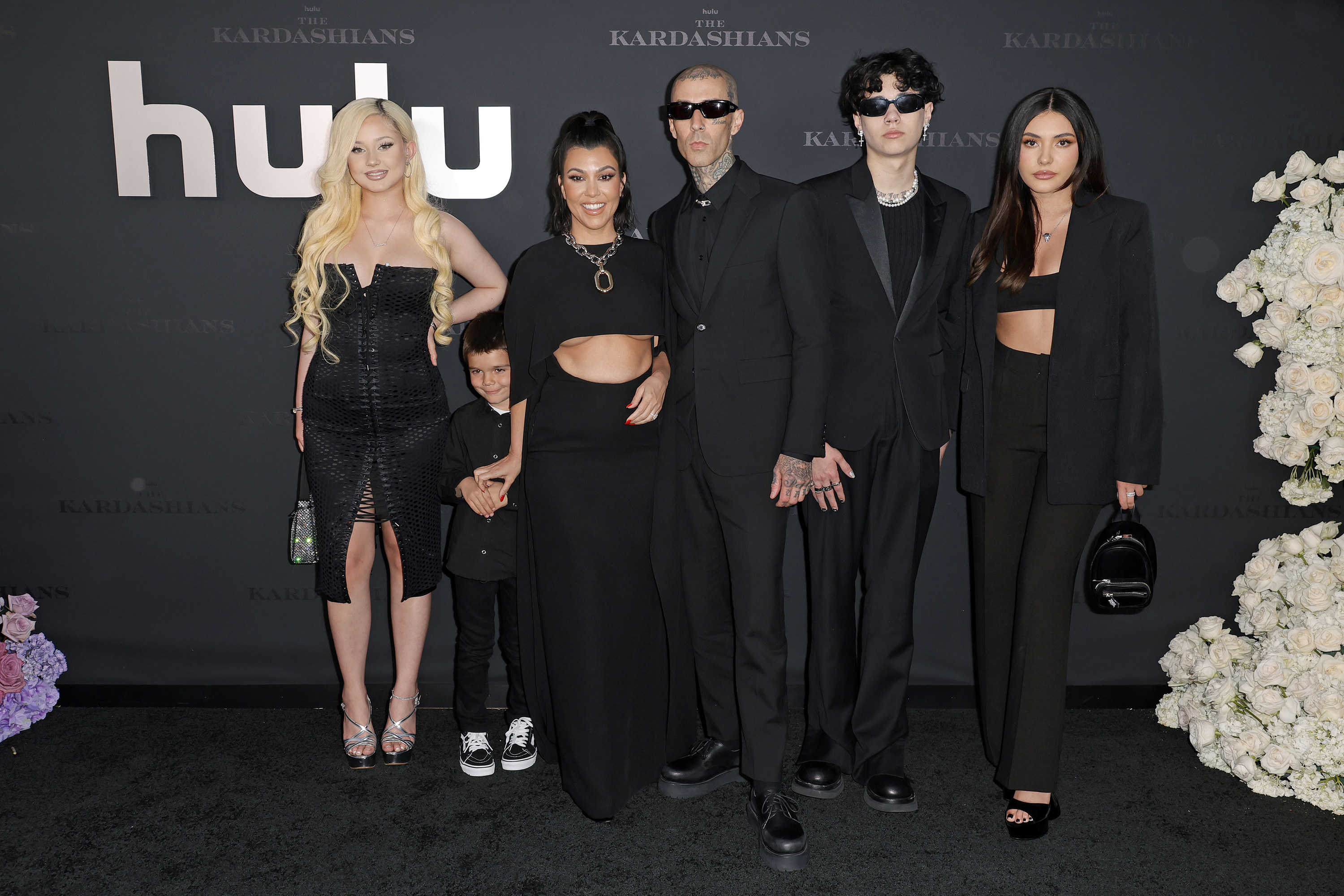 Kourtney and Travis posing with some of their kids