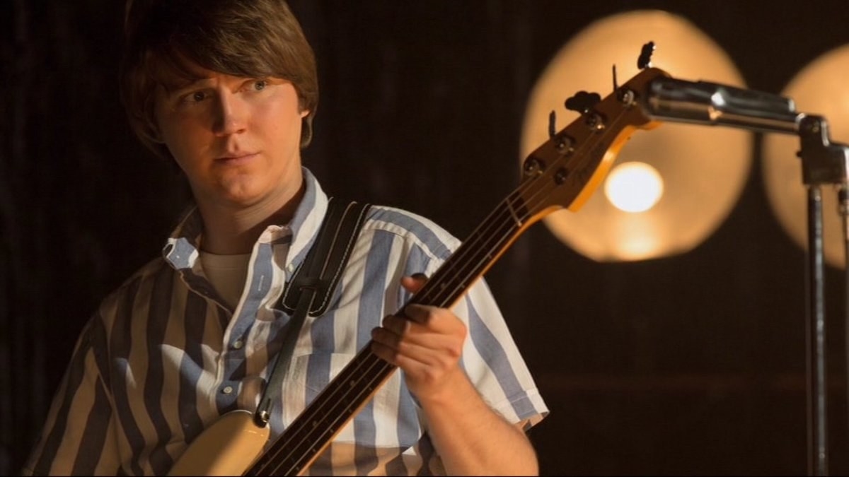 Paul Dano as Brian Wilson, playing a bass guitar
