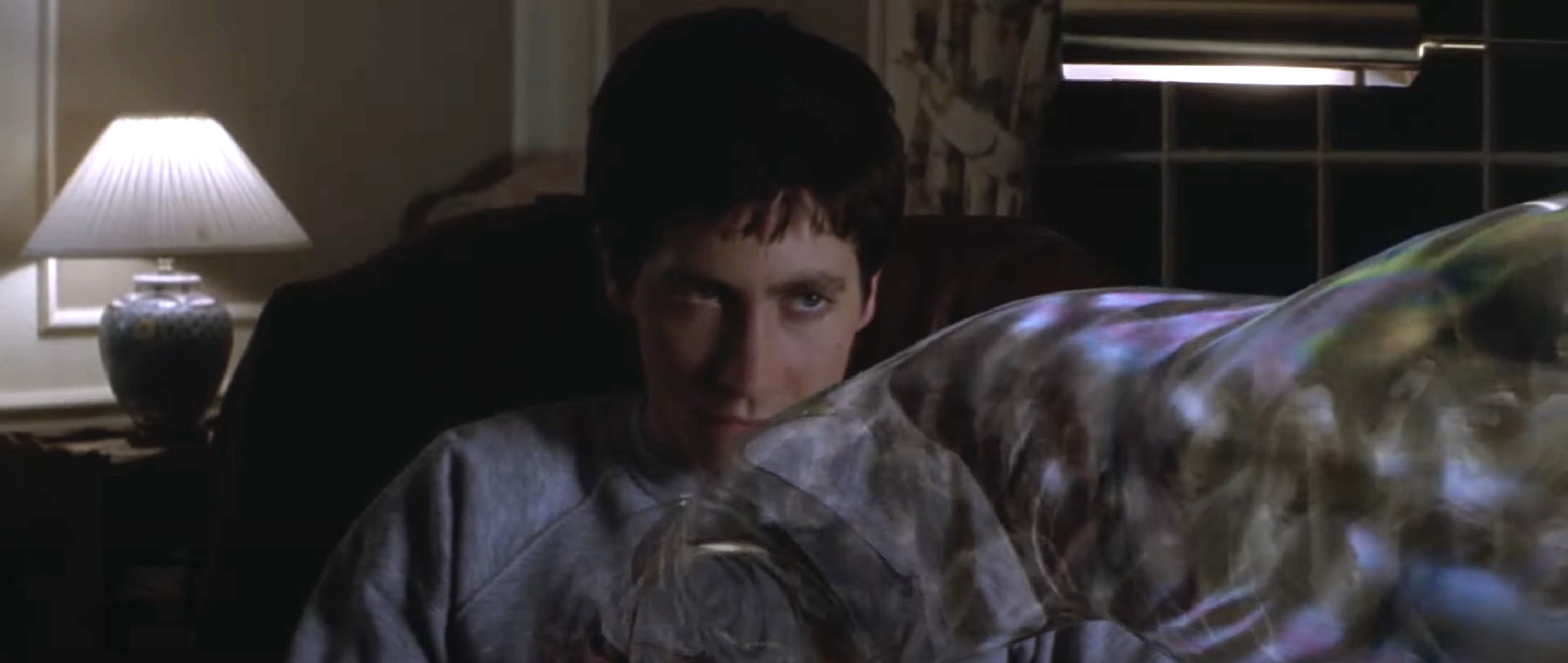 Donnie Darko sitting on the couch looking grim