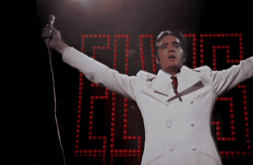 GIF of Elvis onstage holding his arms out and then singing into a microphone