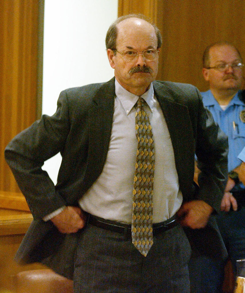 Rader in a suit and tie in a courtroom