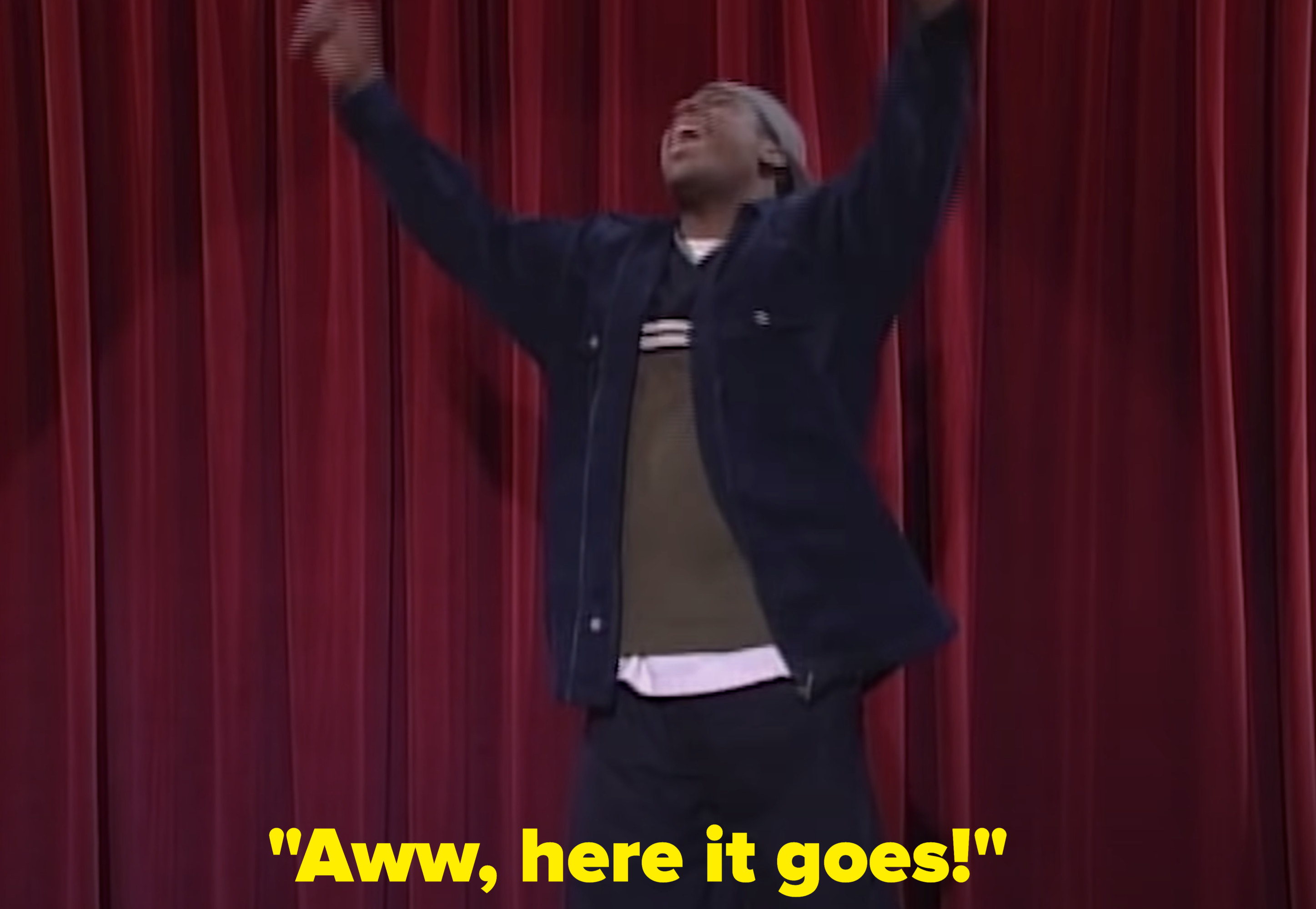 Kel with his hands in the air shouting, &quot;Aww here it goes!&quot;