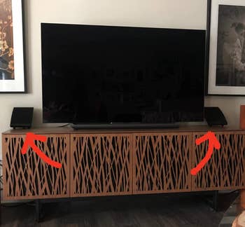 Reviewer image of the black speakers next to a TV