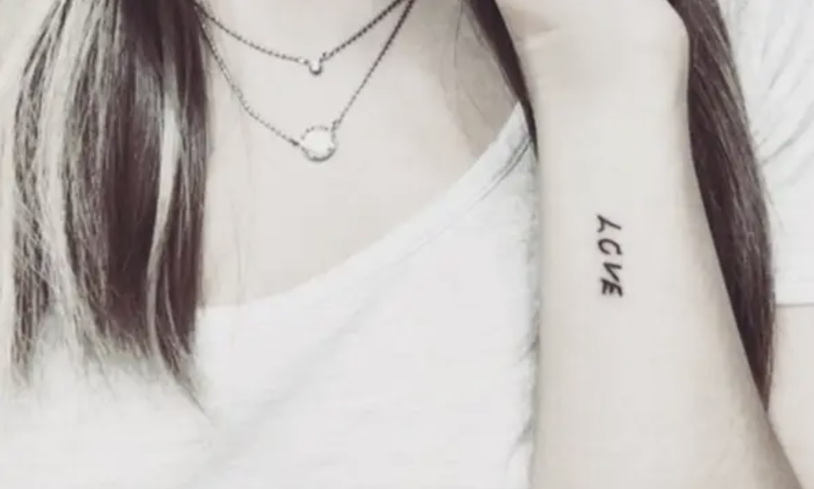 The word &quot;love&quot; tattooed on someone&#x27;s arm