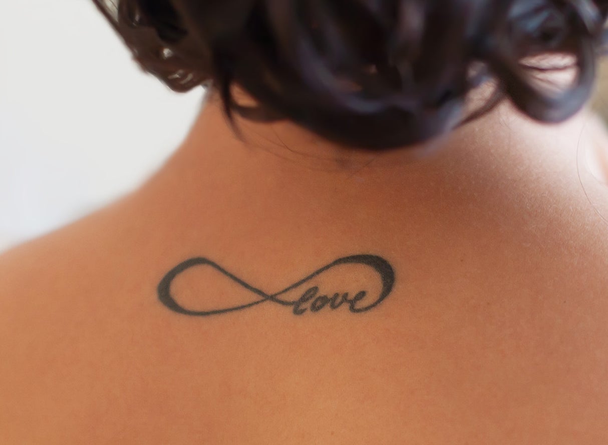 An infinity loop tattoo that has the word &quot;love&quot; in it