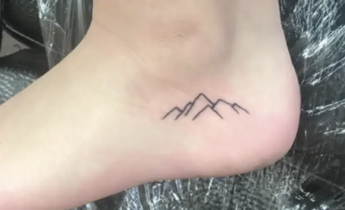 Mountain tattoo on someone&#x27;s ankle