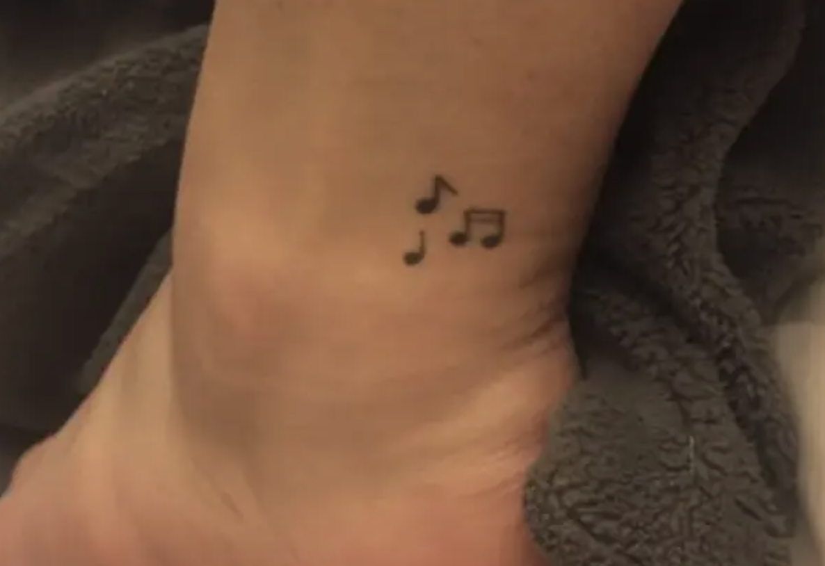 Music notes tattooed on someone&#x27;s ankle