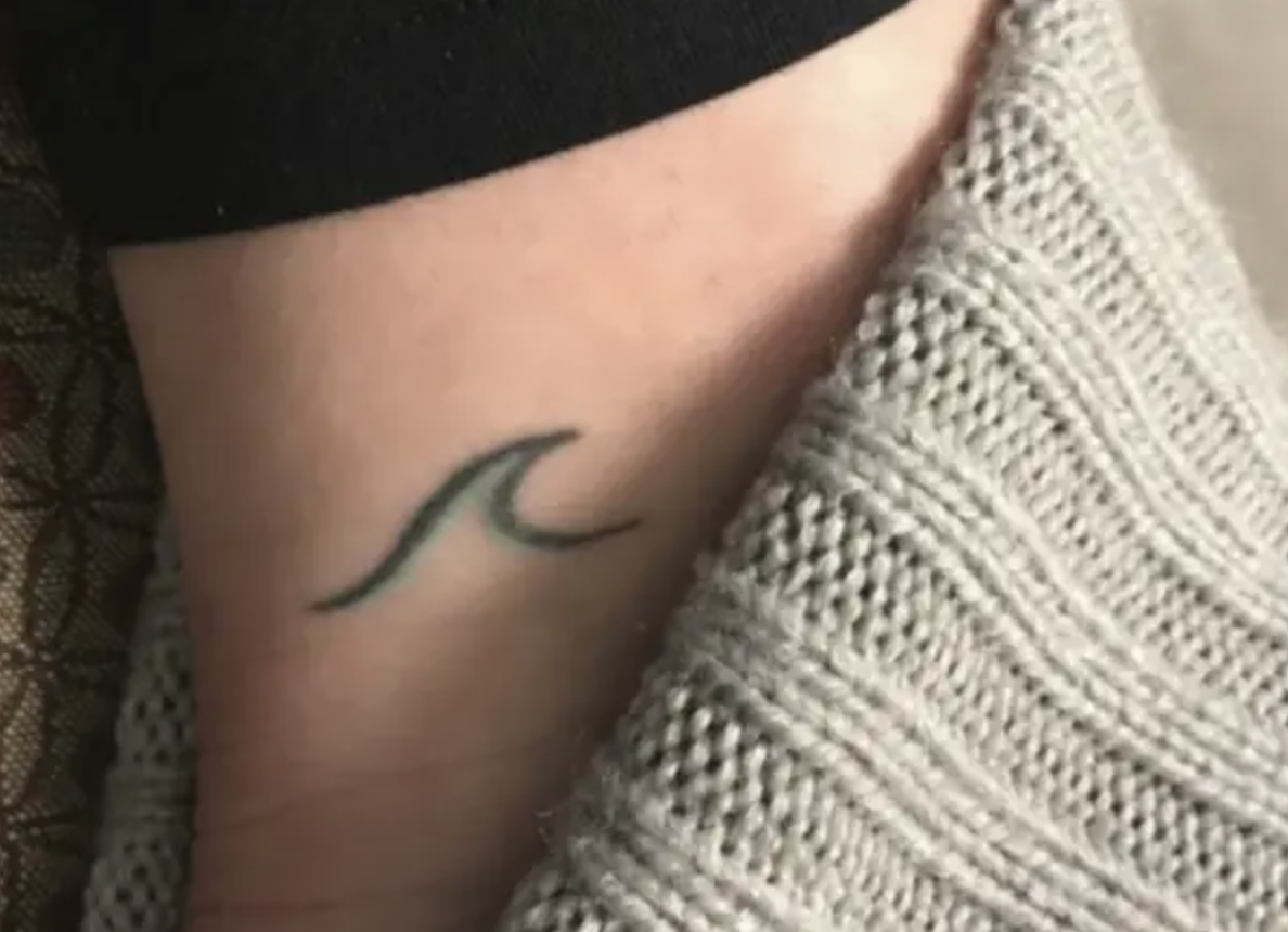 A wave tattoo on someone&#x27;s ankle