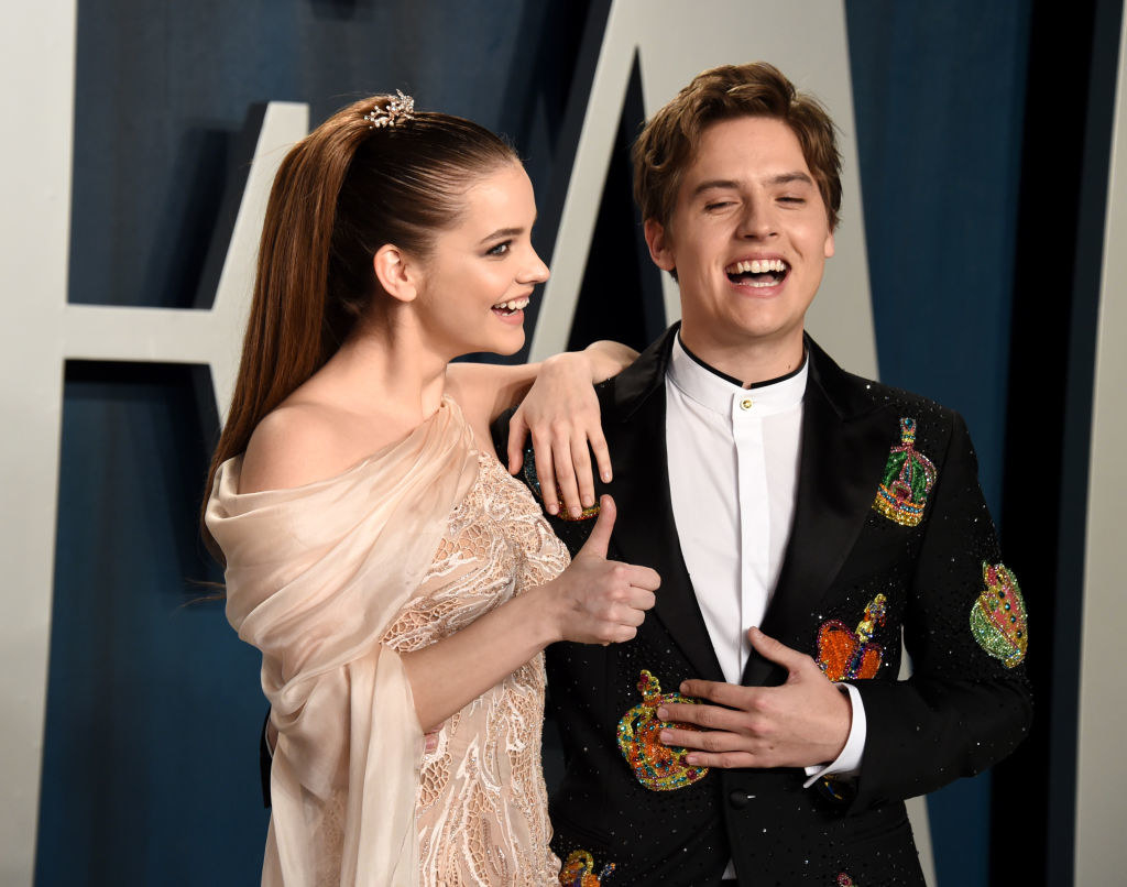 Barbara giving a thumbs up and Cole laughing on a red carpet