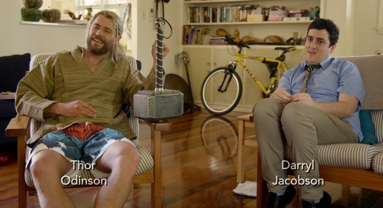 Darryl sitting on a couch while Thor is in a chair next to him