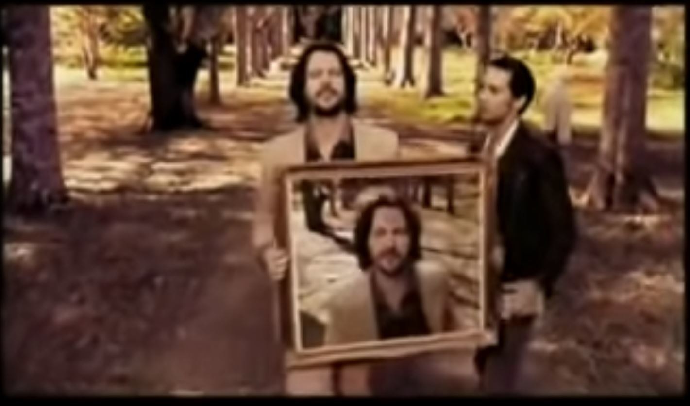 Bernard Fanning handing off a picture of himself to someone else