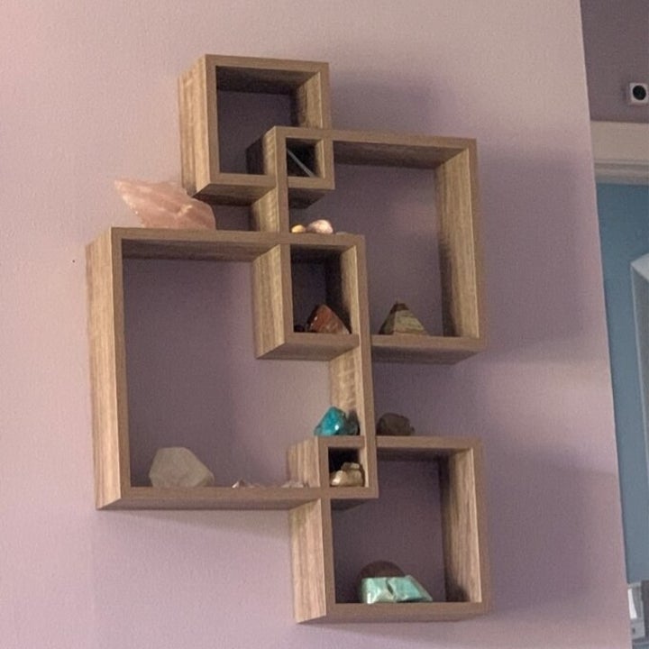a reviewer photo of the accent shelf with crystals on it