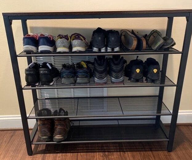 a reviewer photo of shoes on the black shelf