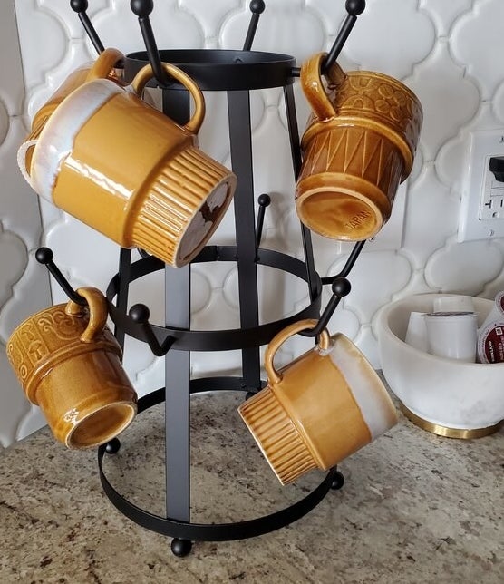 a reviewer photo of mugs on the mug tree