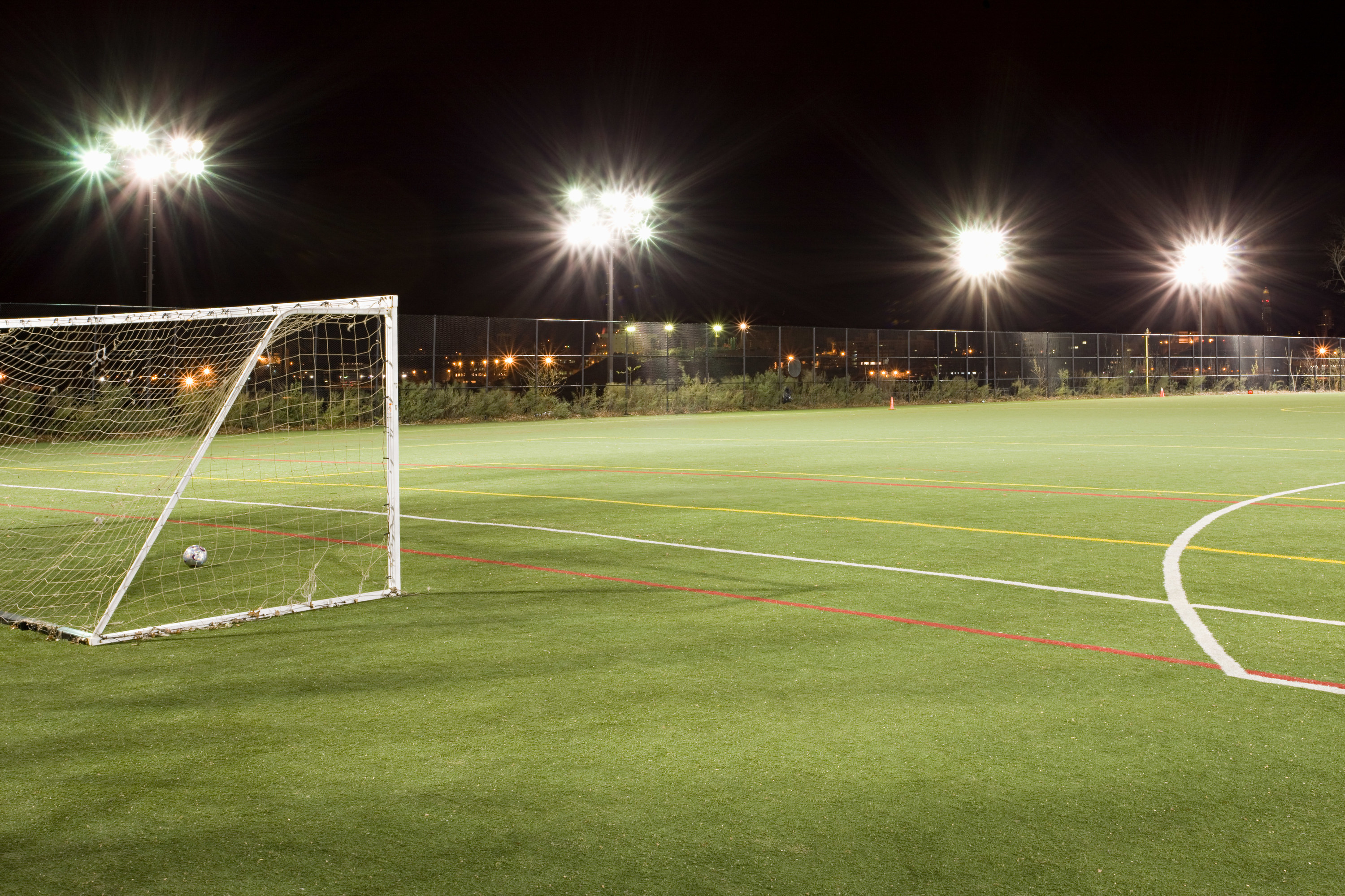 A soccer field lit up at night.