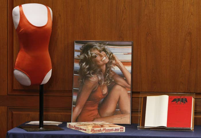 The poster of Farrah Fawcett smiling in a red bathing suit next to the bathing suit
