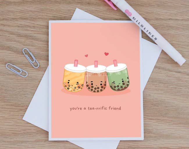 Pink greeting card with yellow, brown, and green bubble teas