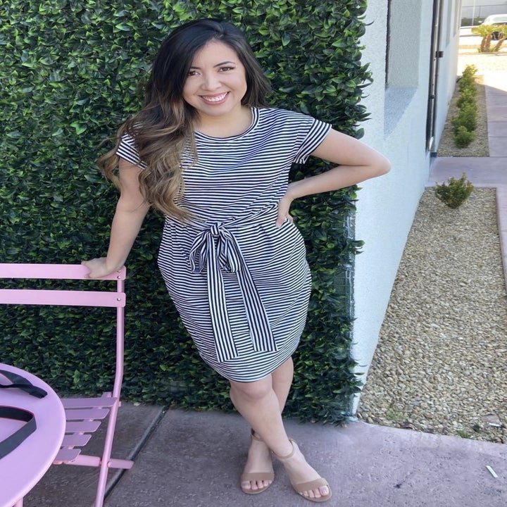 reviewer wearing the striped dress