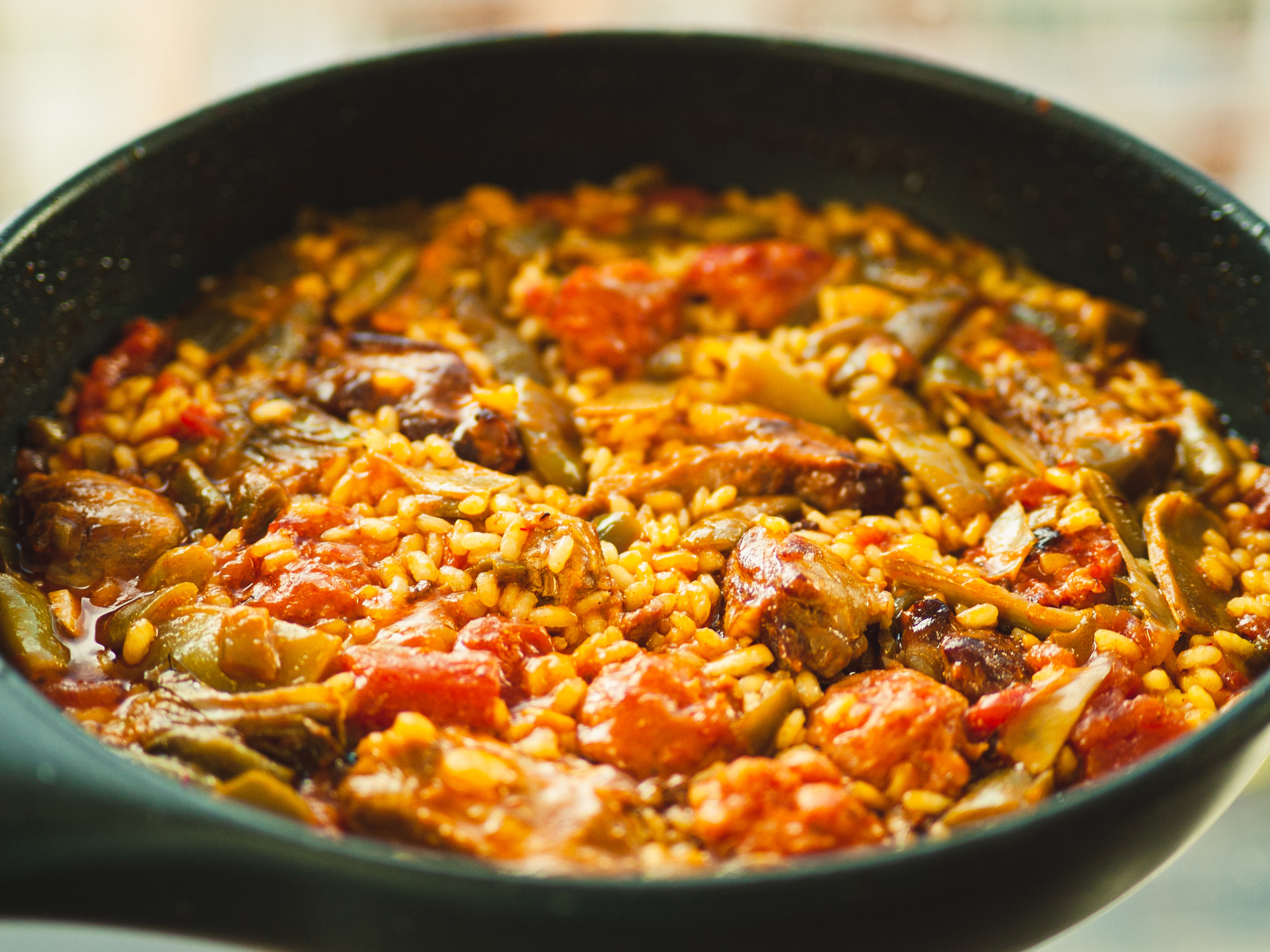 Close view of Spanish paella with tomato rice.